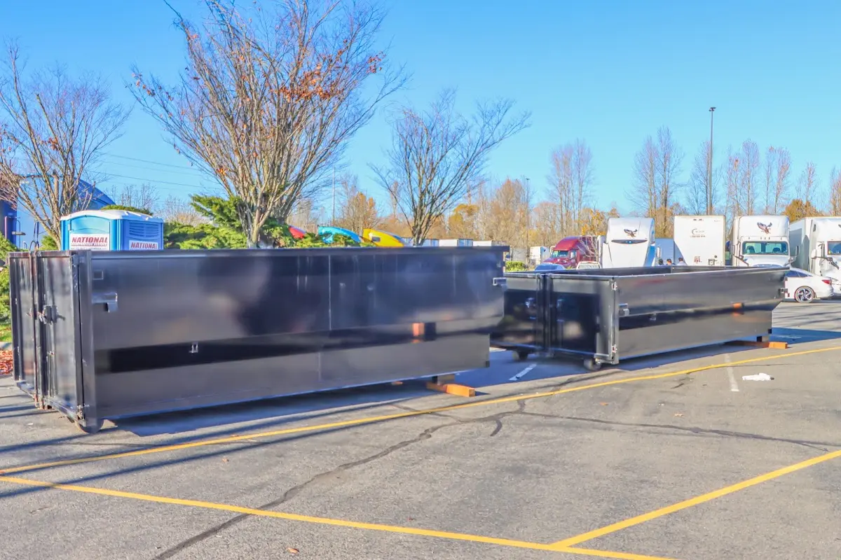 Professional dumpster rental service with roll-off container on residential driveway in Bremen